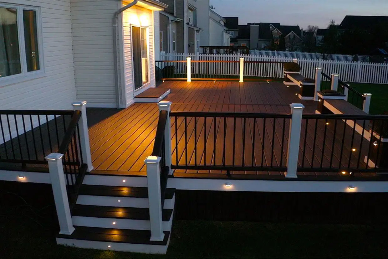 Coordinated landscape lighting with deck illumination including garden lights and uplighting
