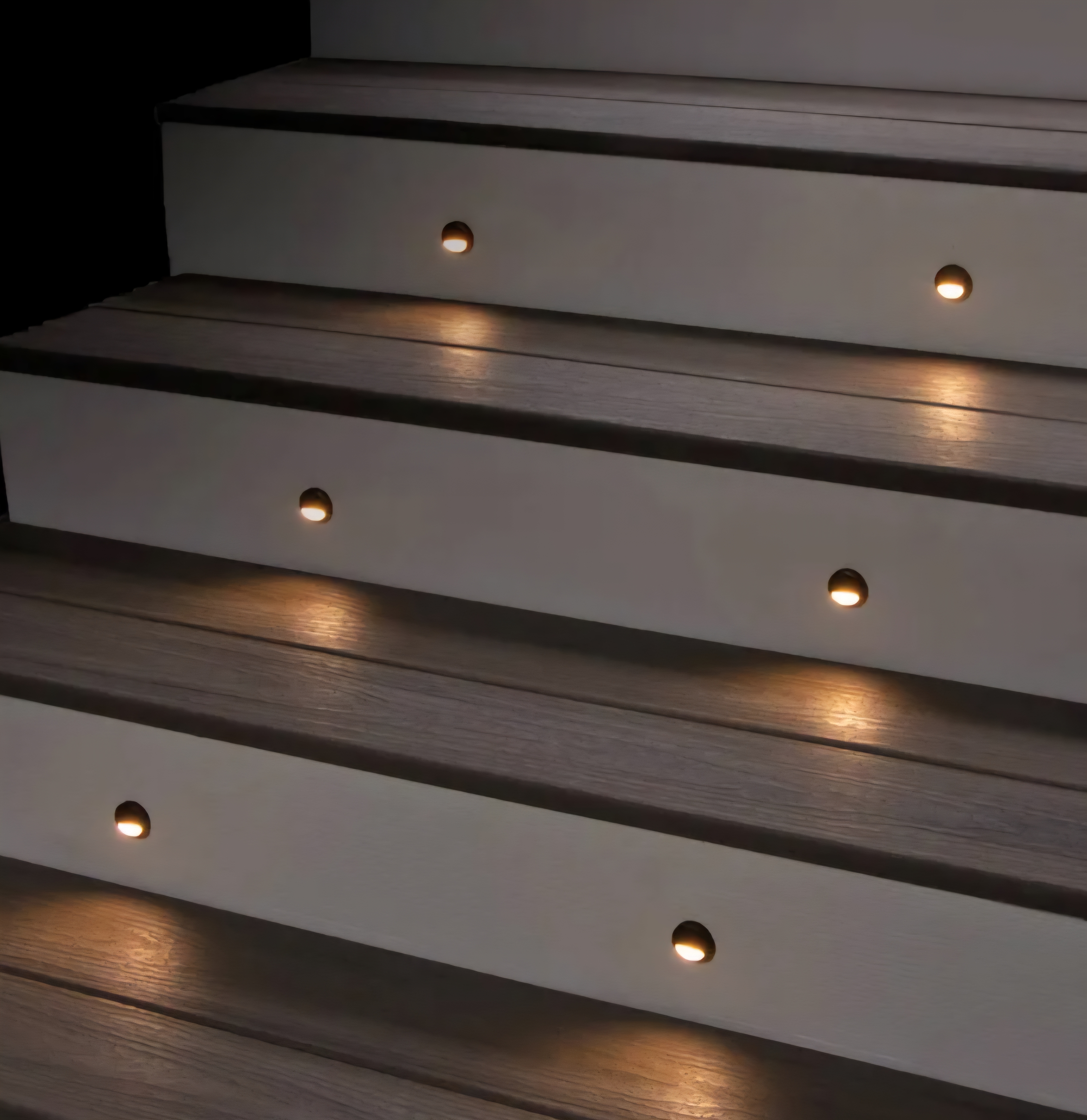 Recessed LED step lights built into deck stairs for safety and ambient lighting