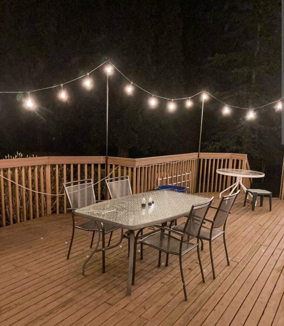 Warm Edison bulb string lights creating cozy cafe-style atmosphere on outdoor deck