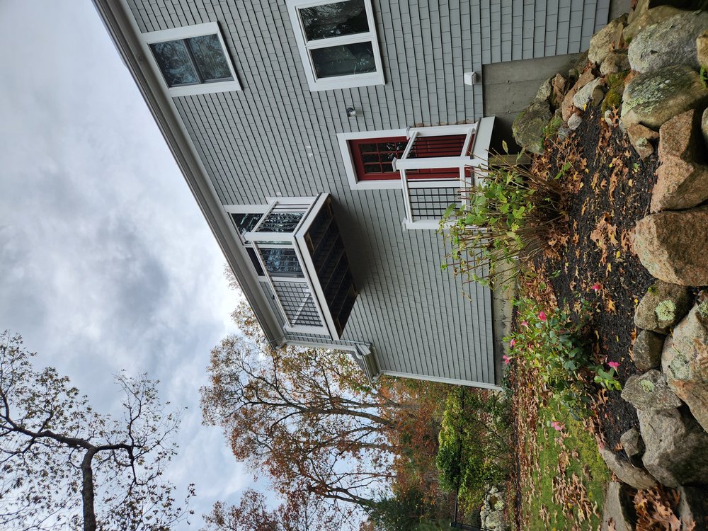 Matching garage and balcony Timbertech white composite railing with round black aluminum balusters